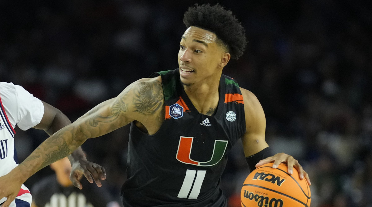 Miami guard Jordan Miller drives the ball