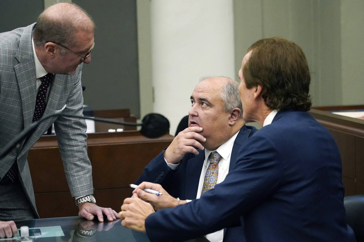Davis, center, conferred with his lawyers during a court appearance.