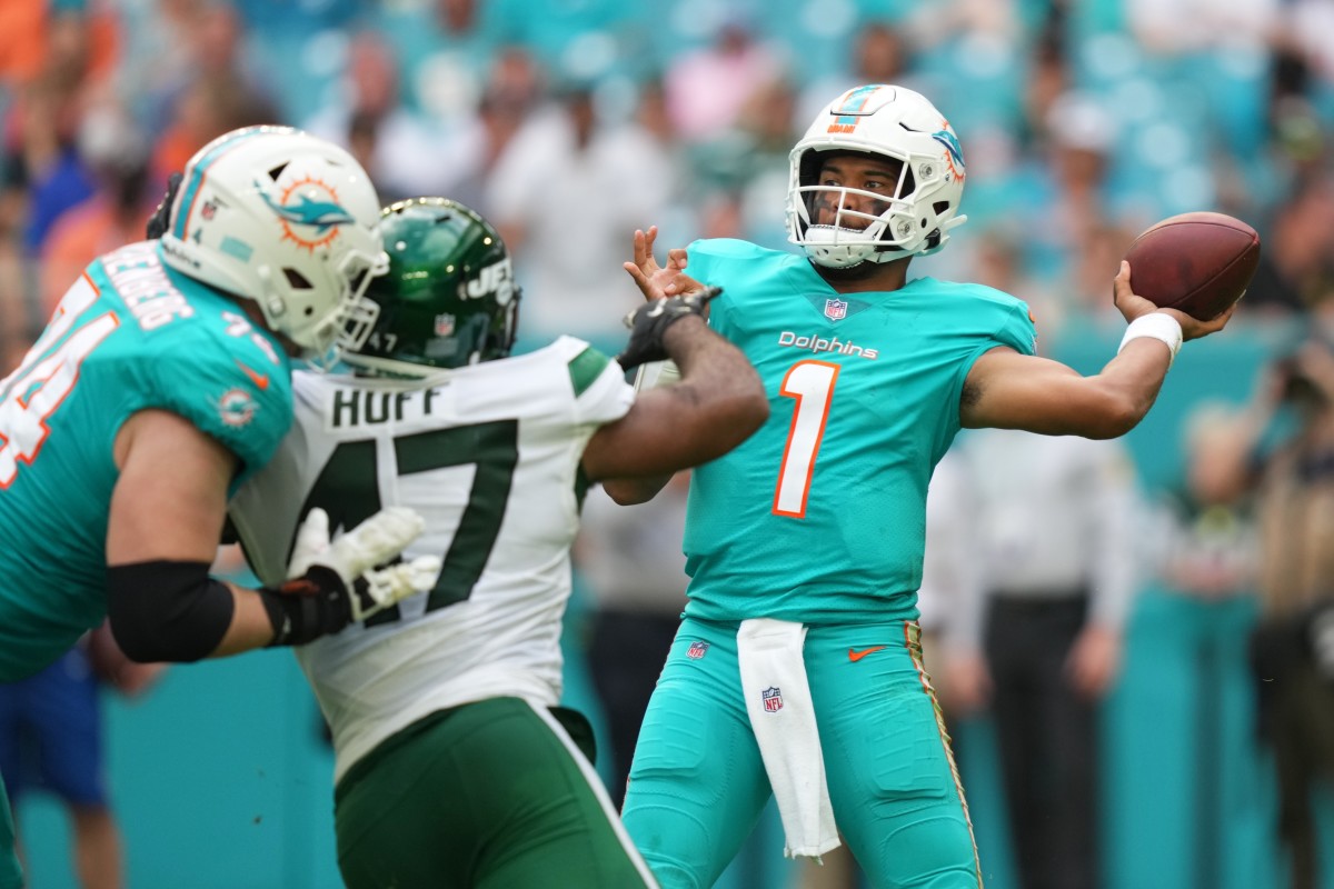 Dolphins' QB Tua Tagovailoa is pressured by Jets' edge rusher Bryce Huff