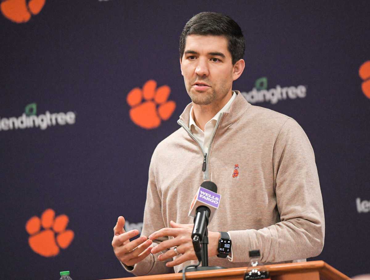 Clemson director of athletics Graham Neff talks into a microphone at a press conference