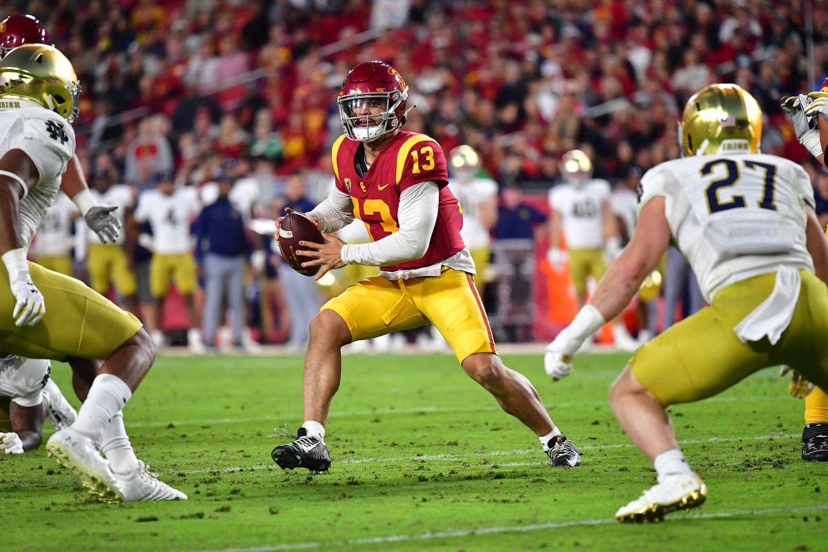 Nov 26, 2022; Los Angeles, California, USA; Southern California Trojans quarterback Caleb Williams (13) runs the ball against the Notre Dame Fighting Irish during the first half at the Los Angeles Memorial Coliseum. Mandatory Credit: Gary A. Vasquez-USA TODAY Sports