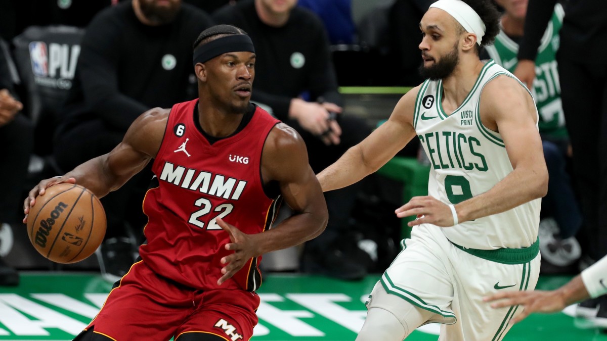 Miami Heat forward Jimmy Butler dribbles against Boston Celtics guard Derrick White.