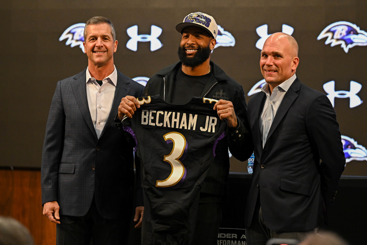 Baltimore Ravens wide receiver Odell Beckham Jr. (M), head coach John Harbaugh (L), and executive vice president & general manager Eric DeCosta (R) pose with his jersey