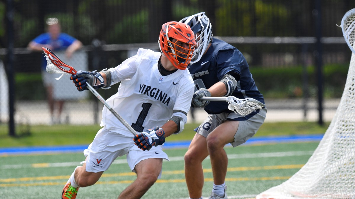 Connor Shellenberger dodges with the ball during the Virginia men's lacrosse game against Georgetown in the quarterfinals of the 2021 NCAA Men's Lacrosse Championship in Hempstead, New York.