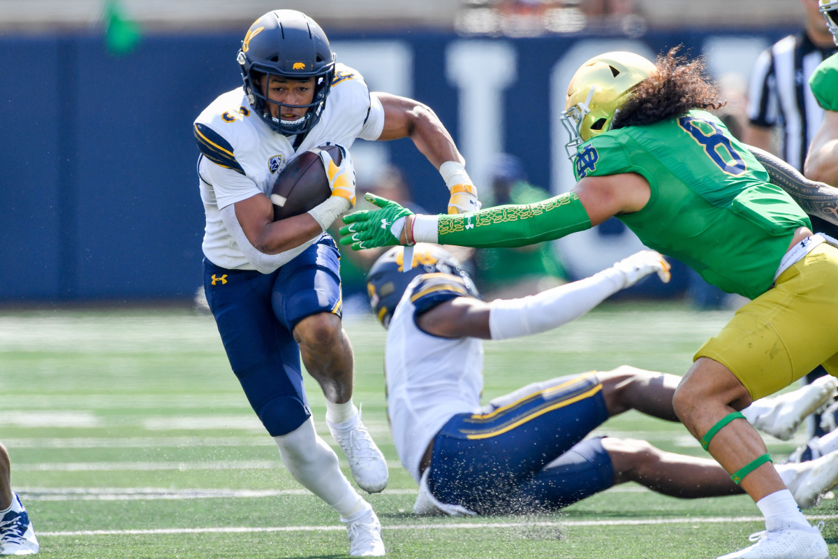 Sep 17, 2022; South Bend, Indiana, USA; California Bears running back Jadyn Ott (6) carries the ball as Notre Dame Fighting Irish linebacker Marist Liufau (8) attempts to tackle in the first quarter at Notre Dame Stadium. Mandatory Credit: Matt Cashore-USA TODAY Sports