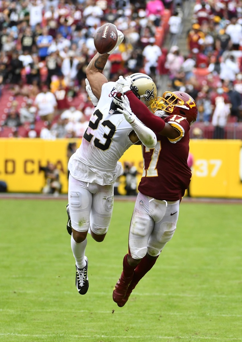 Oct 10, 2021; New Orleans Saints cornerback Marshon Lattimore (23) breaks up a pass intended for Washington receiver Terry McLaurin (17). Mandatory Credit: Brad Mills-USA TODAY