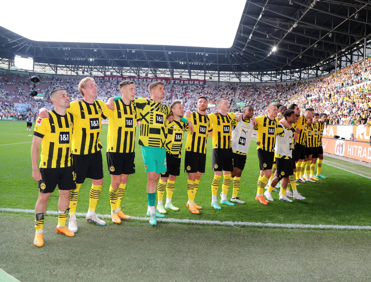Players from Borussia Dortmund pictured celebrating after winning 3-0 at Augsburg to go top of the Bundesliga table on the penultimate weekend of the 2022/23 season