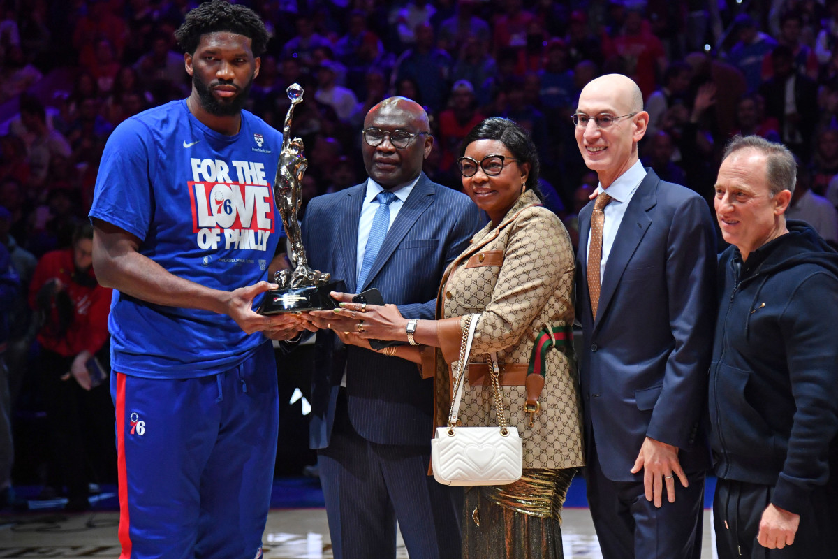 Philadelphia 76ers center Joel Embiid (21) holds the MVP trophy with his parents Thomas and Christine, along with NBA Commissioner Adam Silver and 76ers owners Josh Harris