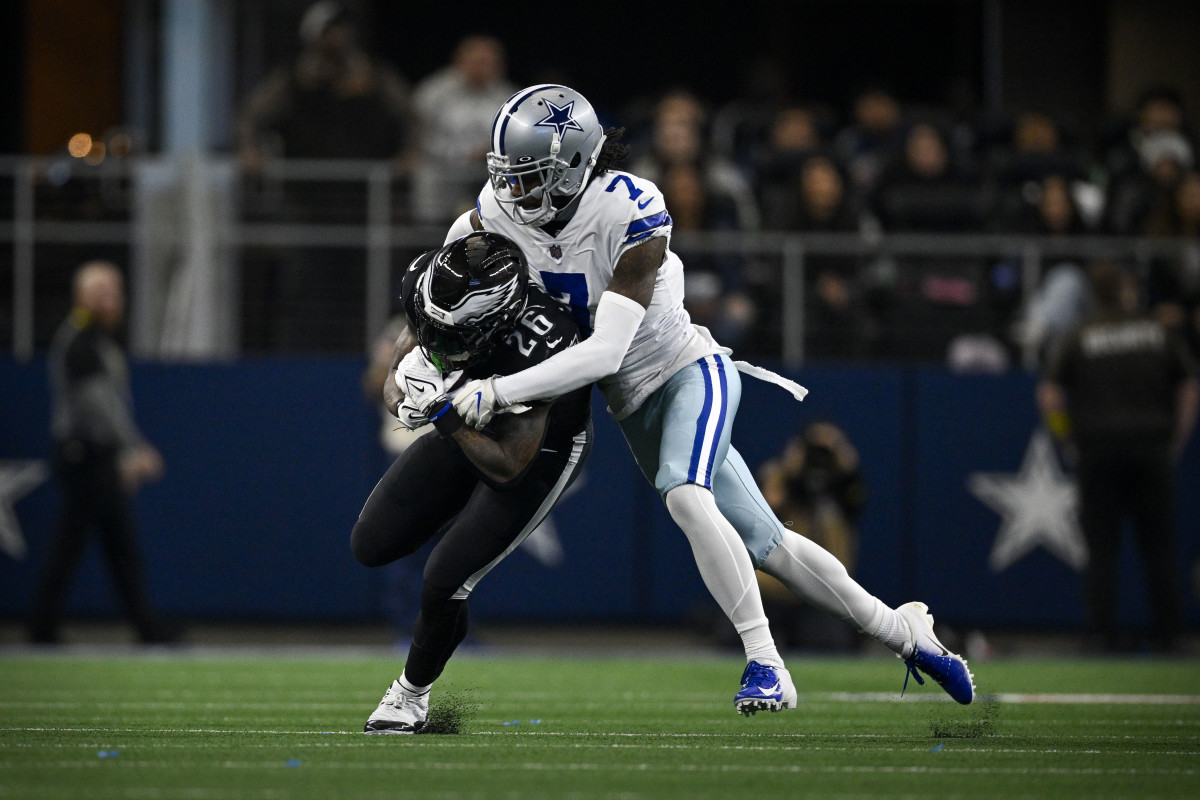 Dallas Cowboys cornerback Trevon Diggs tackles Philadelphia Eagles running back Miles Sanders