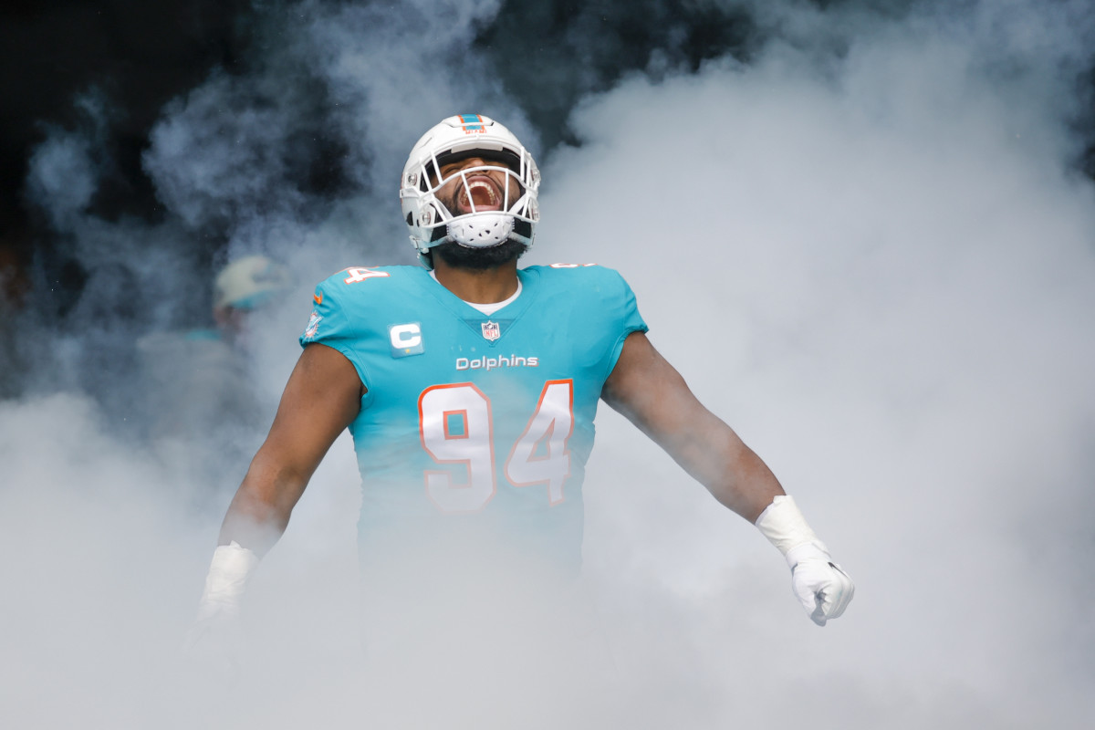 Miami Dolphins defensive tackle Christian Wilkins looks up yelling in celebration as smoky fog comes up around him