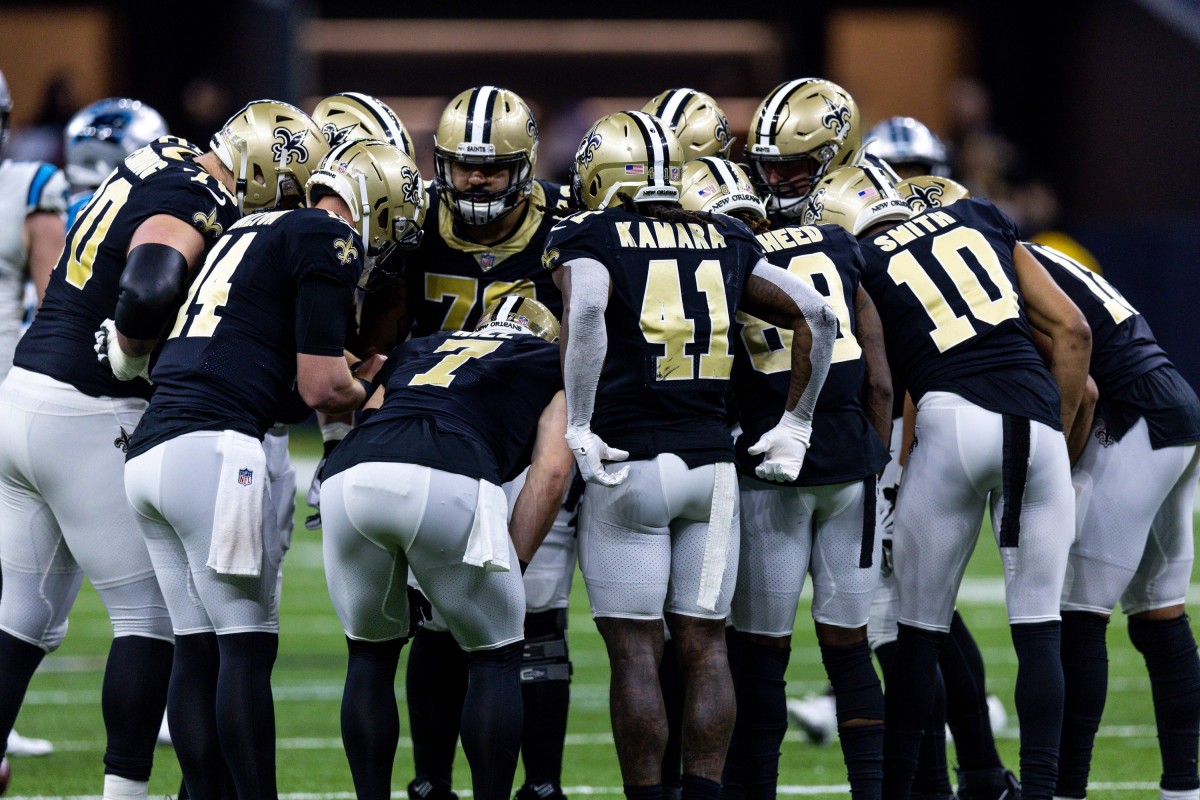 Jan 8, 2023; New Orleans Saints huddle before a play against the Carolina Panthers. Mandatory Credit: Stephen Lew-USA TODAY Sports