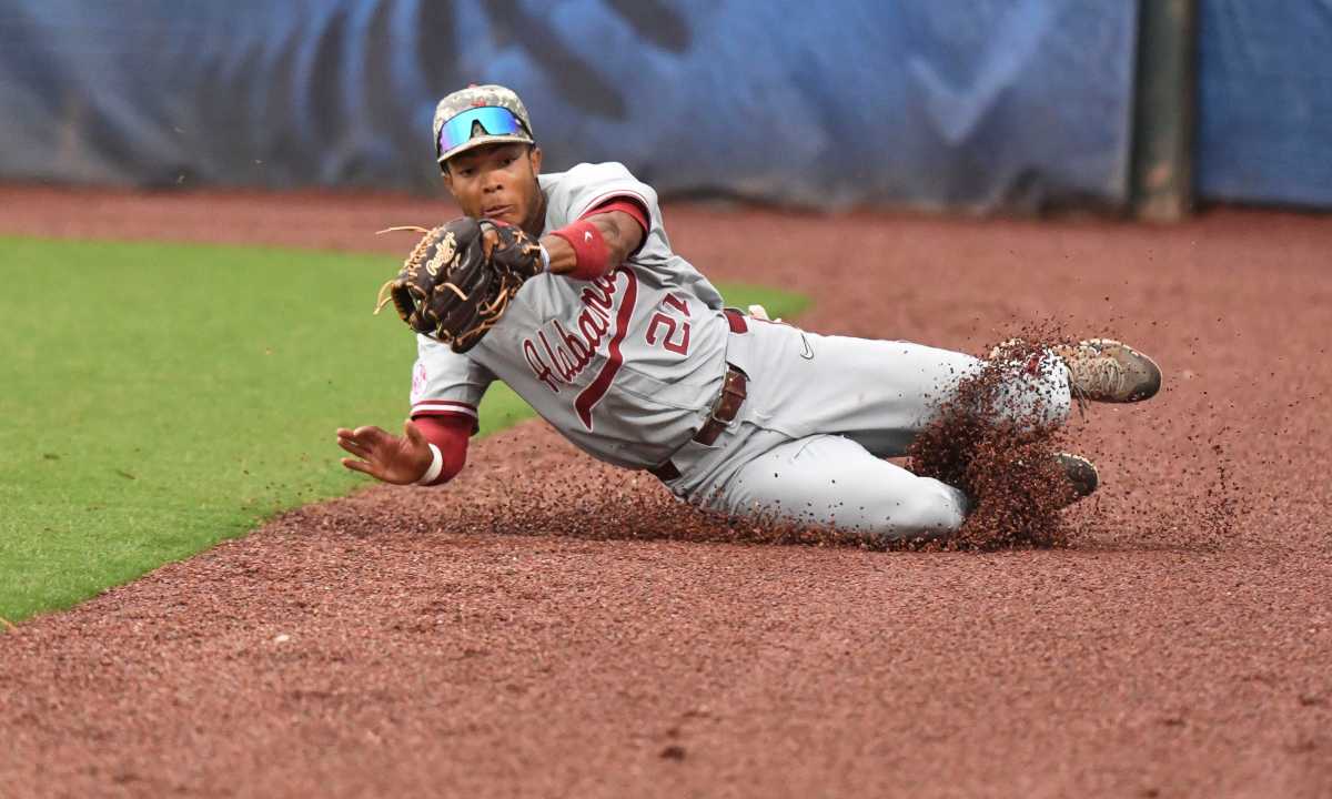 Alabama outfielder Andrew Pinckney (21) makes a sliding catch in foul territory to record an out against Kentucky during the opening round of the SEC Baseball Tournament at the Hoover Met Tuesday, May 23, 2023.