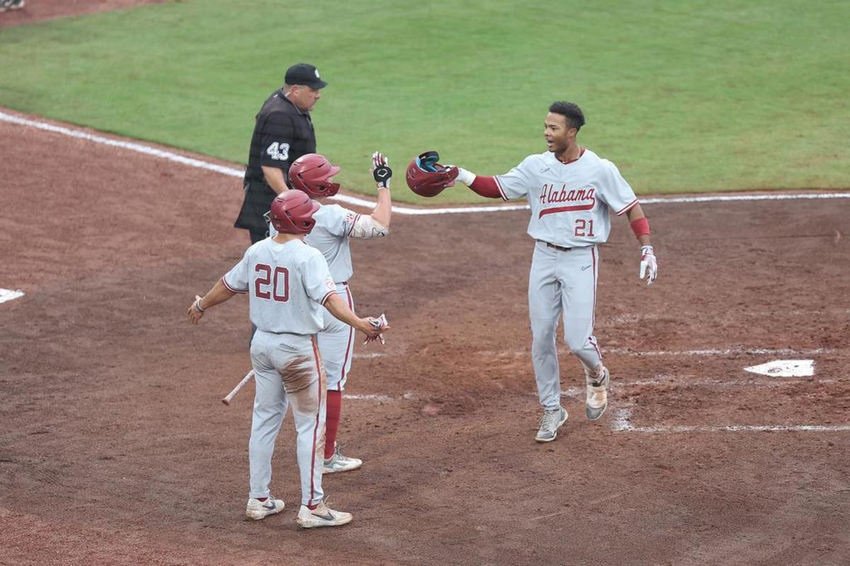 Alabama baseball player Andrew Pinckney (21) scores a run against Kentucky at Hoover Met in Birmingham, AL on Tuesday, May 23, 2023.