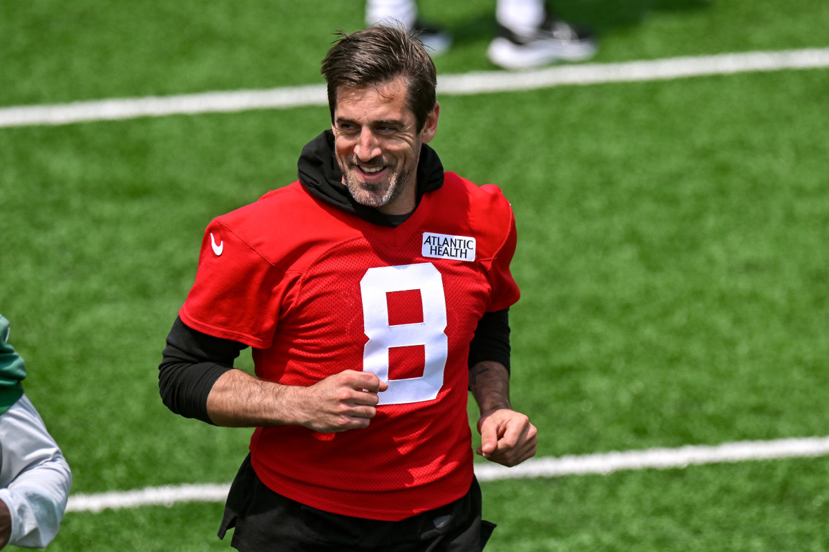 Aaron Rodgers (8) smiles at Jets OTAs