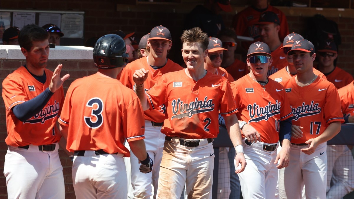 Kyle Teel celebrates with the UVA dugout after scoring a run during the Virginia baseball game against Louisville at Disharoon Park.