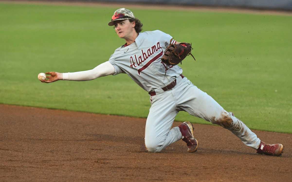 Alabama first baseman Drew Williamson (18) makes a play at first and throws to the pitcher covering to record an out against Florida during the second round of the SEC Baseball Tournament at the Hoover Met Wednesday, May 24, 2023.