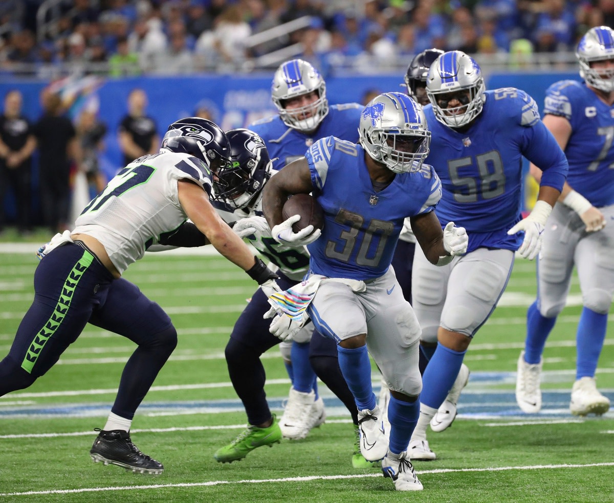 Oct. 2, 2022; Detroit Lions running back Jamaal Williams runs past Seattle Seahawks defenders. 