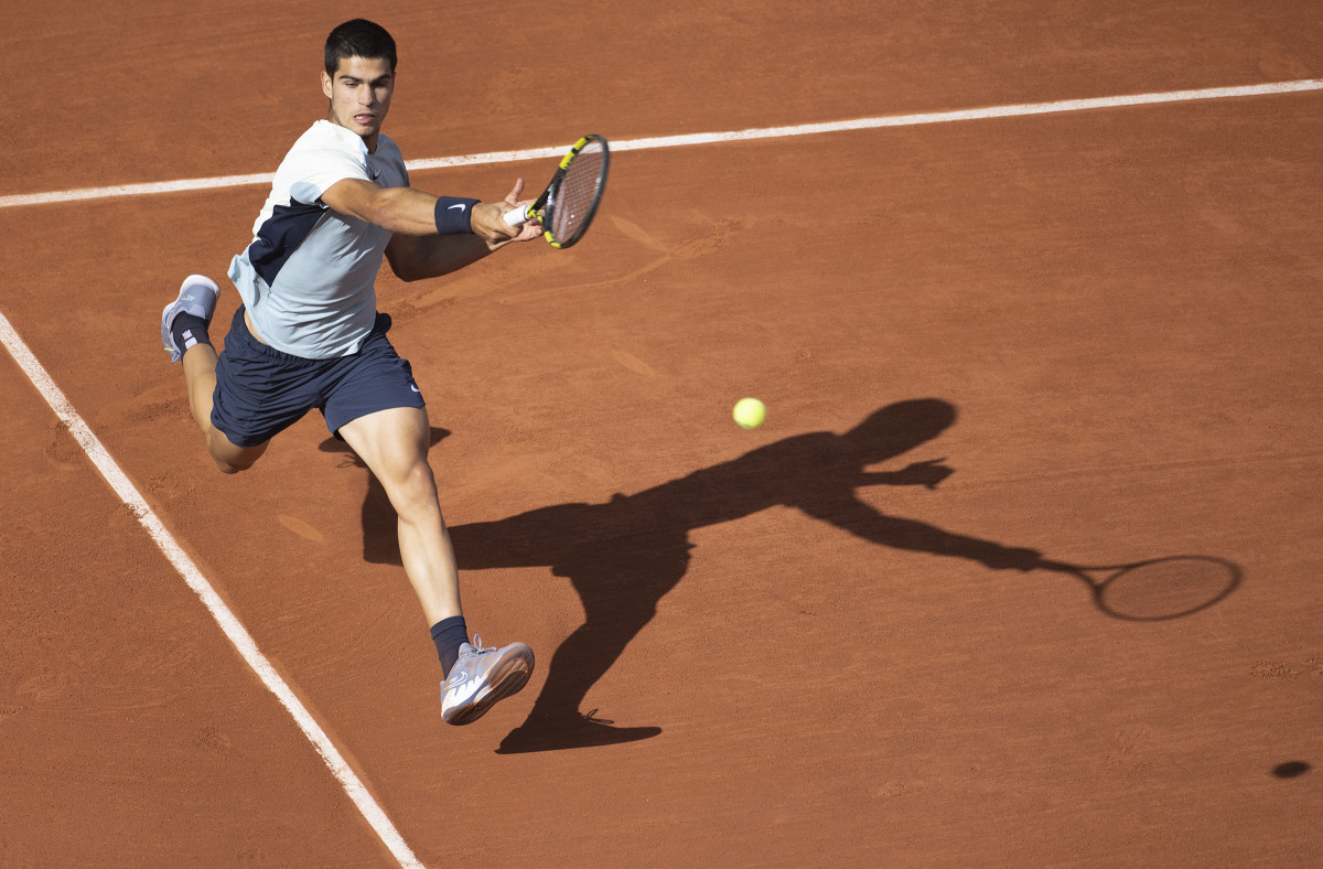 Carlos Alcaraz returns a shot from the baseline.