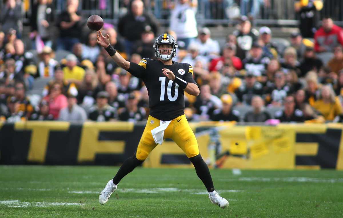 Mitch Trubisky throws the football in a wide leg stance