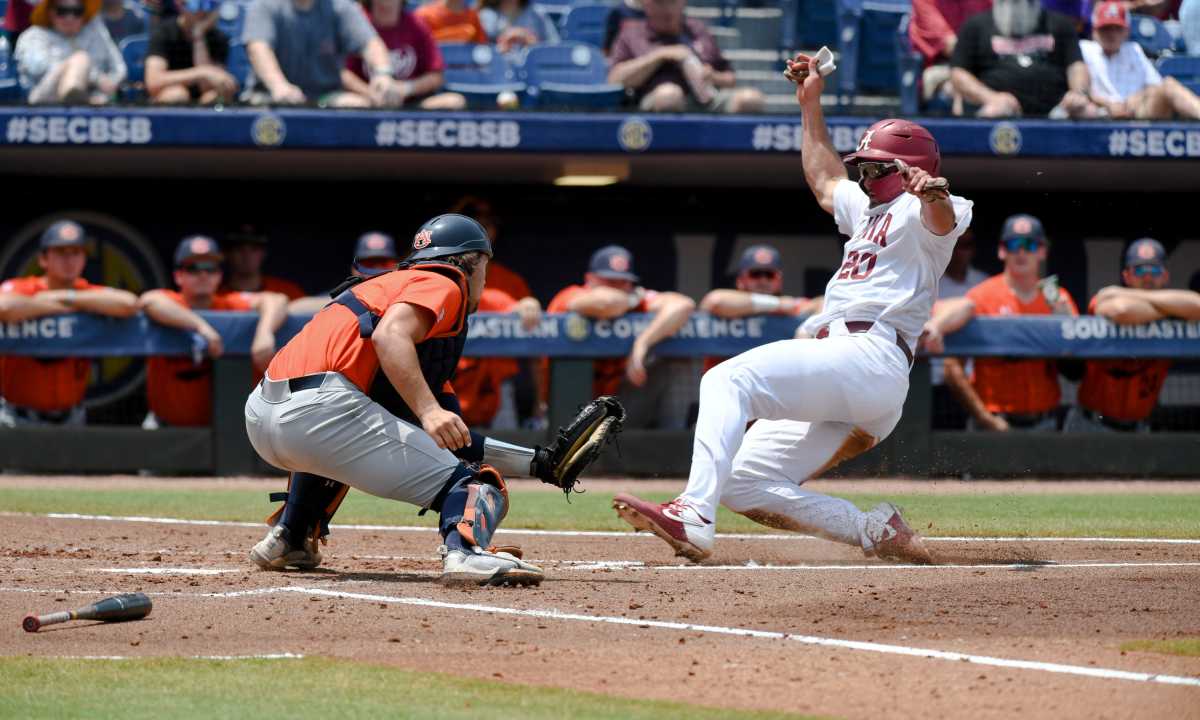 Alabama base runner Tommy Seidl (20) slides safely home as Auburn catch Carter Wright was a fraction late with the tag during the SEC Tournament elimination game Thursday, May 25, 2023, at the Hoover Met. Alabama defeated Auburn 7-4 to advance.