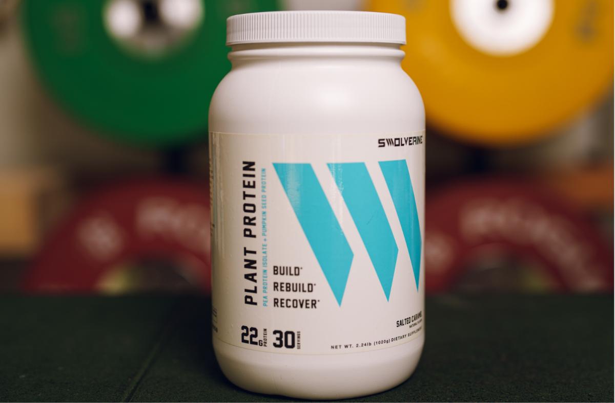A white and turquoise 2-pound container of Swolverine Plant Protein in Salted Caramel flavor