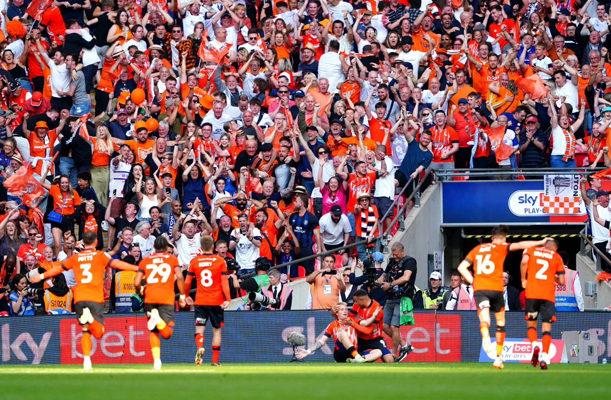 Players and fans from Luton Town pictured celebrating during the 2023 EFL Championship play-off final at Wembley