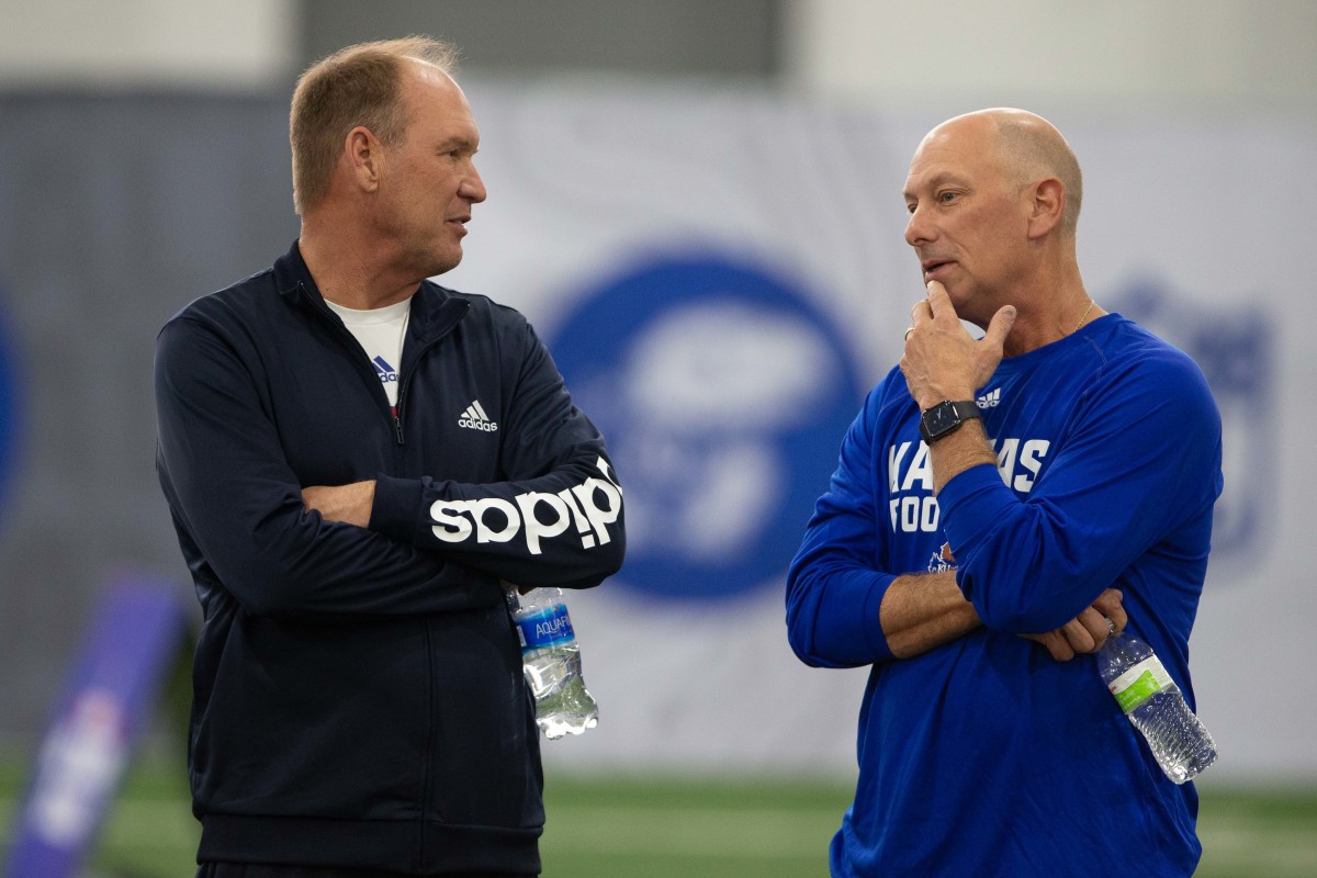 Kansas football coach Lance Leipold (left) talks with recent hire Sean Snyder (right) during Pro Day Friday.