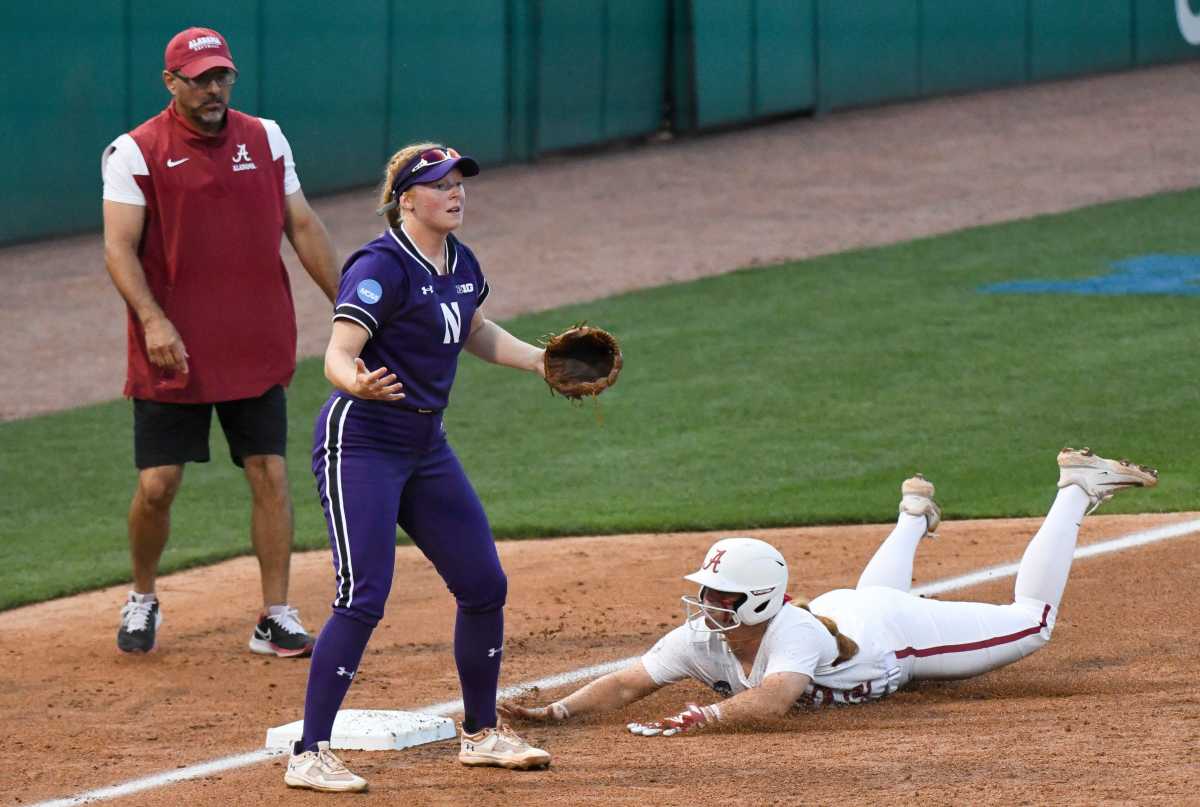 Northwestern third baseman waits for a throw as Alabama base runner Emma Broadfoot (12) slides safely in during the Super Regional game Friday, May 26, 2023, at Rhoads Stadium in Tuscaloosa