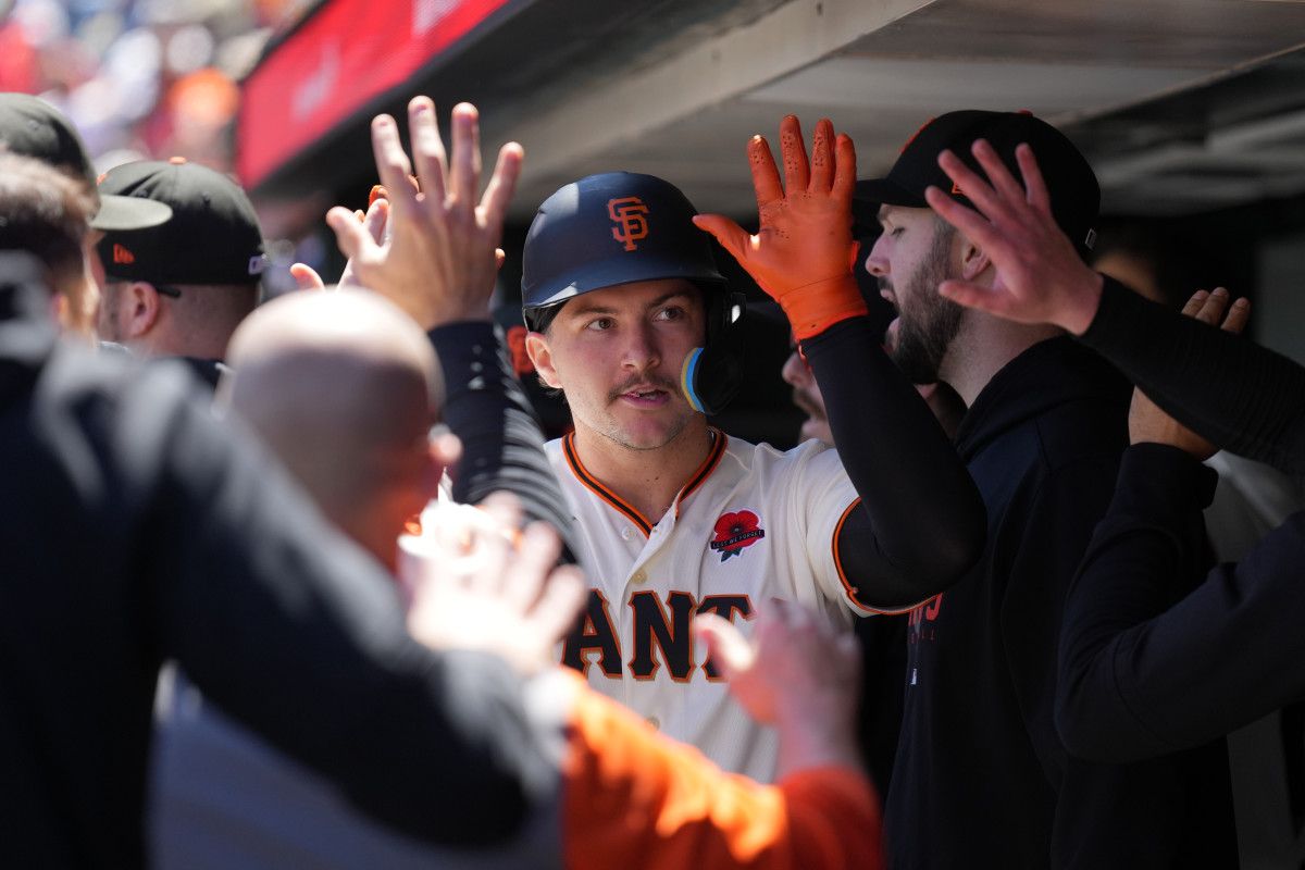 SF Giants catcher Patrick Bailey is congratulated be teammates after scoring a run against the Pittsburgh Pirates on May 29, 2023.