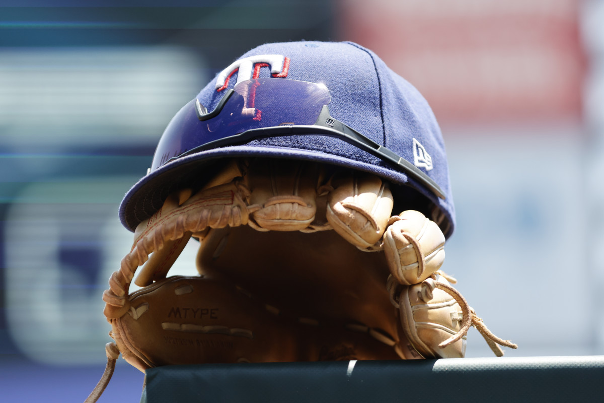 May 29, 2023; Detroit, Michigan, USA; Texas Rangers cap and glove in the dugout in the first inning against the Detroit Tigers at Comerica Park. Mandatory Credit: Rick Osentoski-USA TODAY Sports