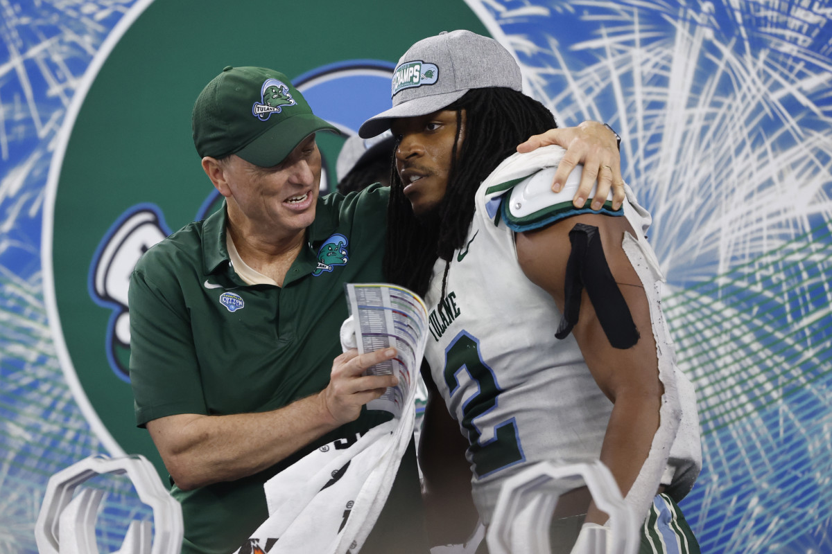 Jan 2, 2023; Arlington, Texas, USA; Tulane Green Wave head coach Willie Fritz celebrates with Tulane Green Wave linebacker Dorian Williams (2) after the game against the USC Trojans in the 2023 Cotton Bowl at AT&T Stadium. Mandatory Credit: Tim Heitman-USA TODAY Sports