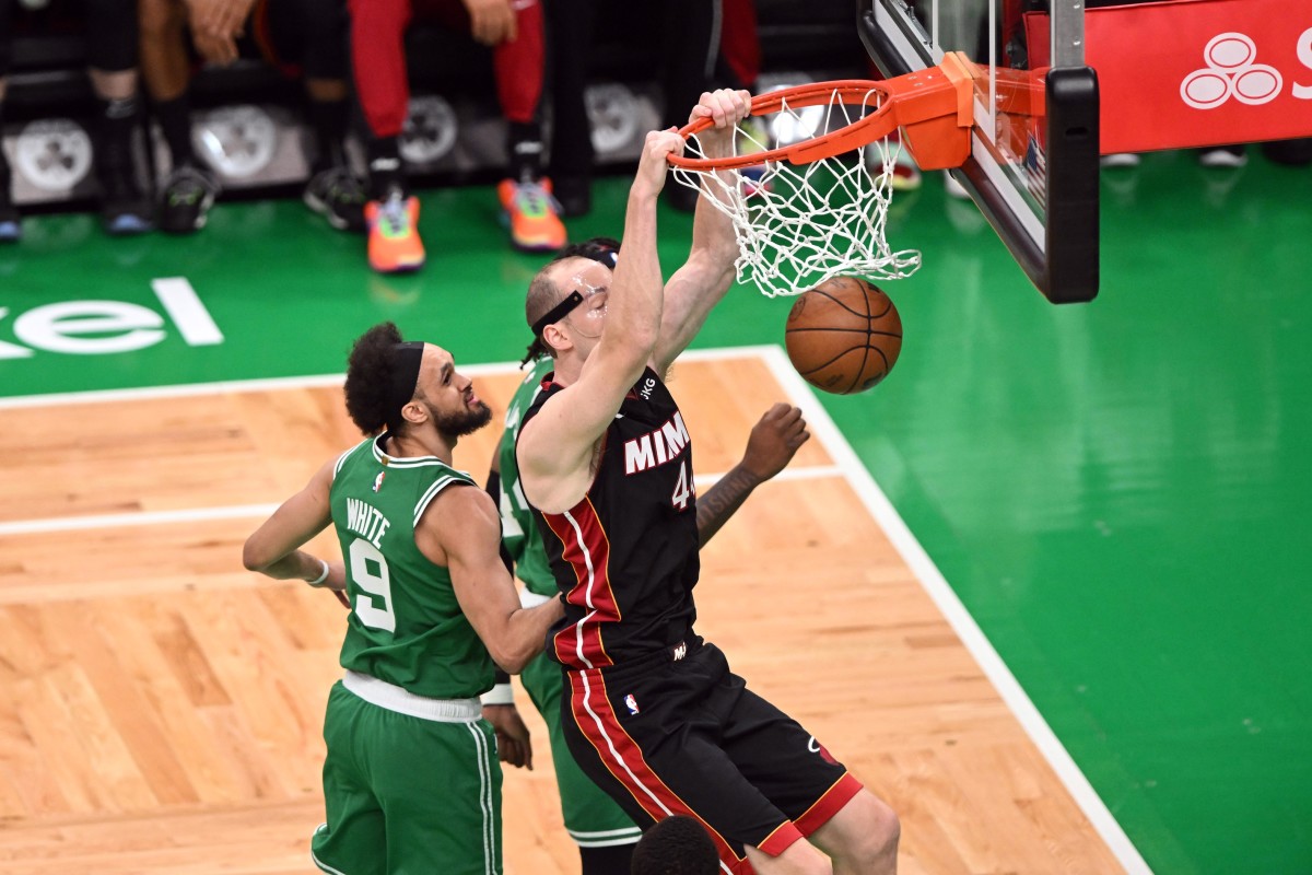 Miami Heat center Cody Zeller (44) shoots against Boston Celtics guard Derrick White (9) and center Robert Williams III (44) in the second quarter during game five of the Eastern Conference Finals for the 2023 NBA playoffs at TD Garden.
