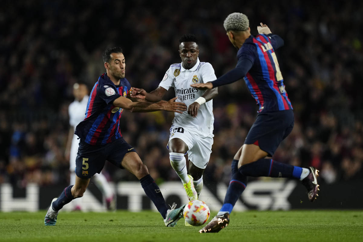 Sergio Busquets (left), Vinicius Junior (center) and Ronald Araujo (right) pictured in action during a Copa del Rey semi-final game between Barcelona and Real Madrid in April 2023