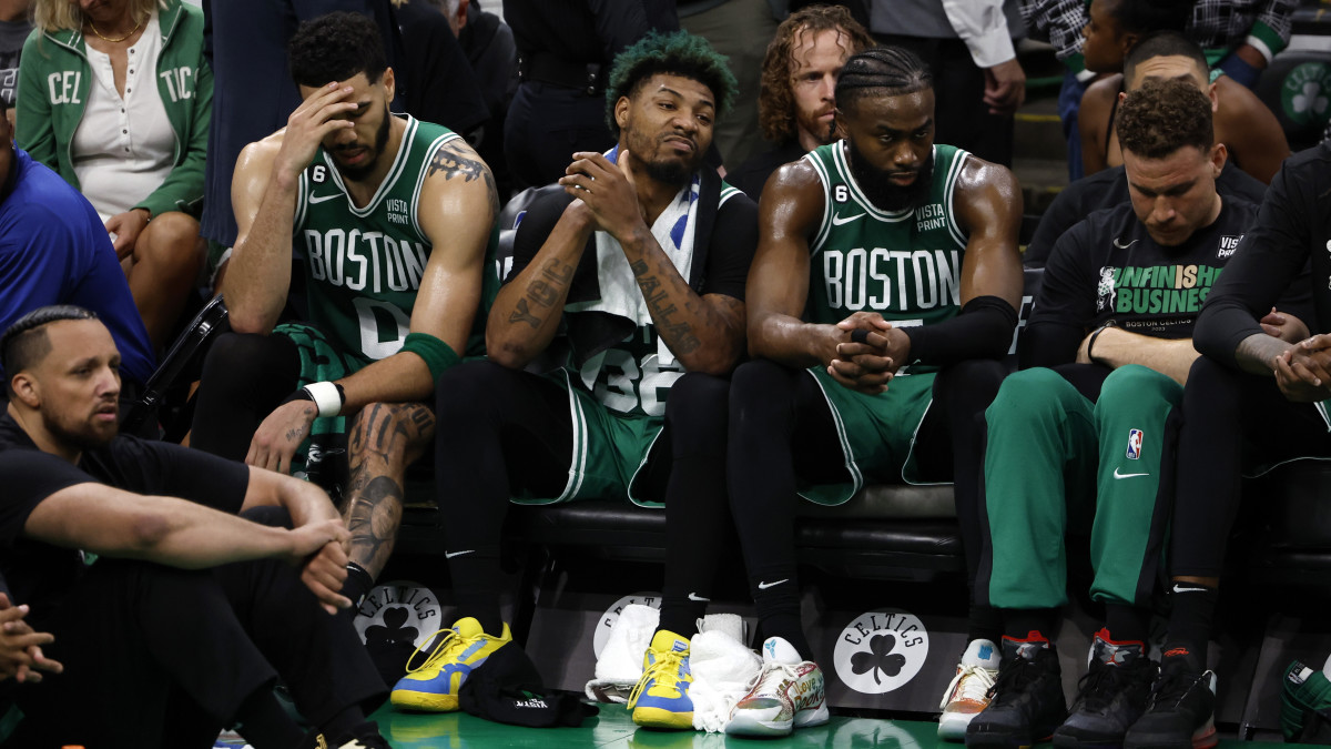 Boston Celtics forward Jayson Tatum, guard Marcus Smart and guard Jaylen Brown react from the bench during the fourth quarter against the Miami Heat in game seven of the Eastern Conference Finals.