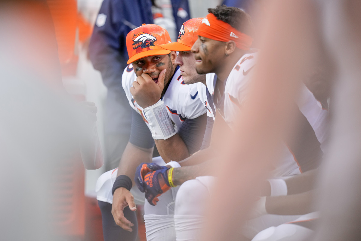 Russell Wilson sitting on the Broncos bench