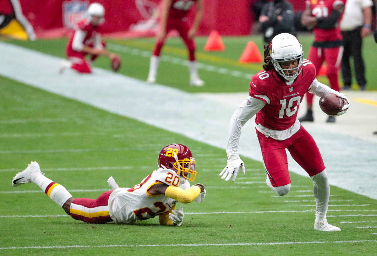 DeAndre Hopkins runs away from a would-be tackler who has fallen down.
