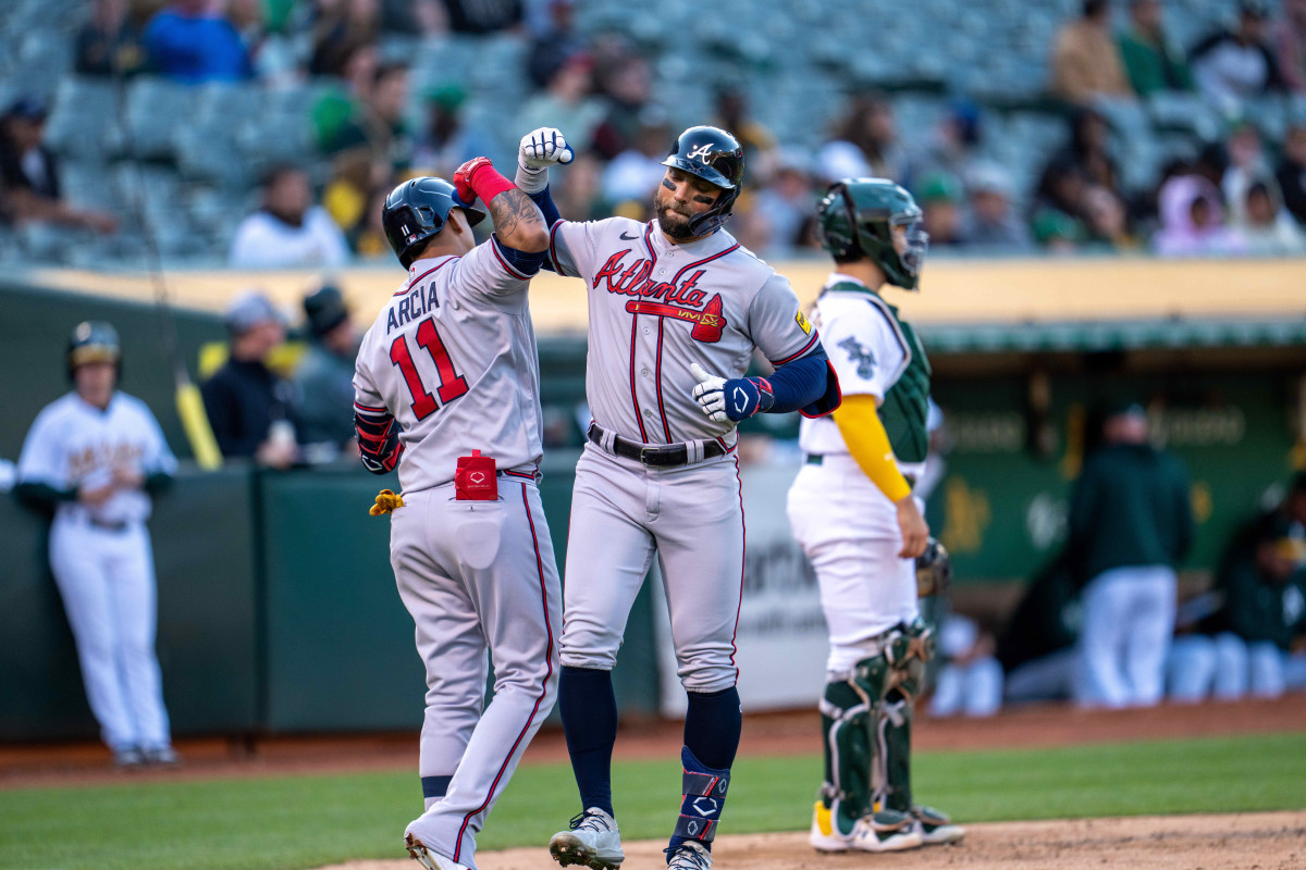 May 30, 2023; Oakland, California, USA; Atlanta Braves left fielder Kevin Pillar (17) celebrates with shortstop Orlando Arcia (11) after hitting a solo homer during the third inning against the Oakland Athletics at Oakland-Alameda County Coliseum.
