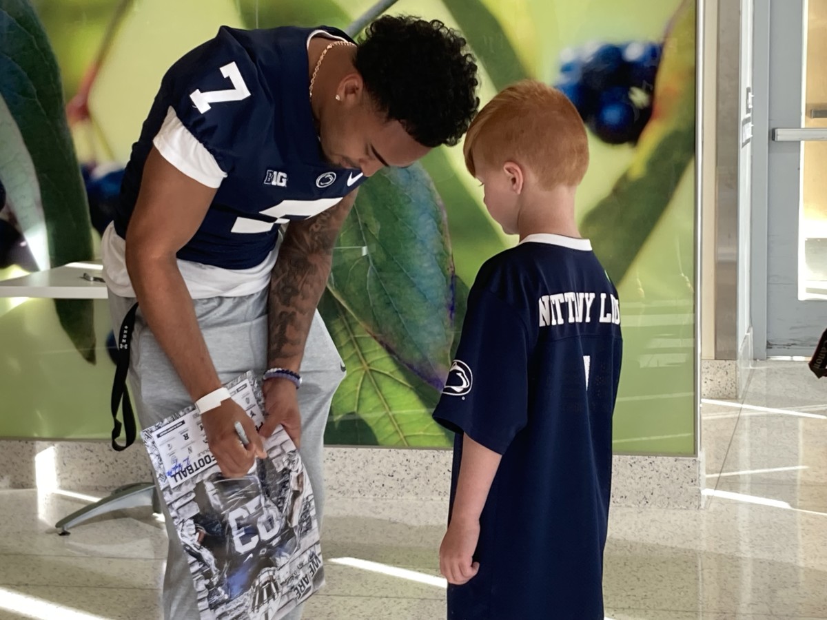 Penn State receiver Kaden Saunders signs an autograph during a team visit to Penn State Health Children's Hospital in Hershey.