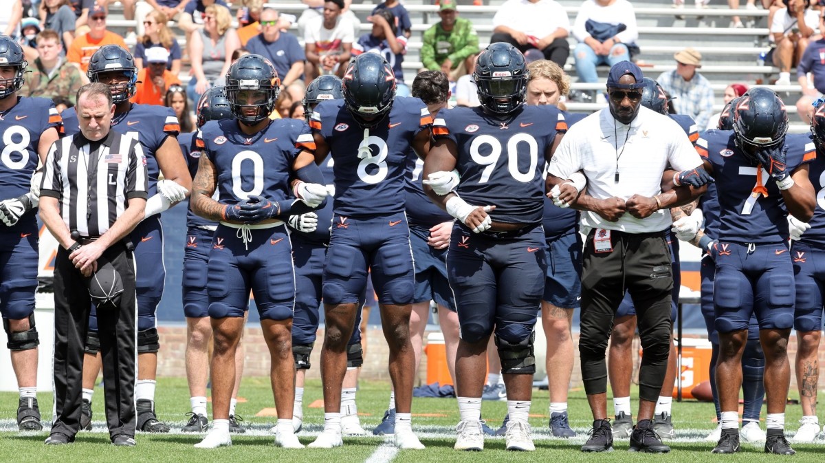 The Virginia football team stands for the national anthem before the Virginia football spring team at Scott Stadium.