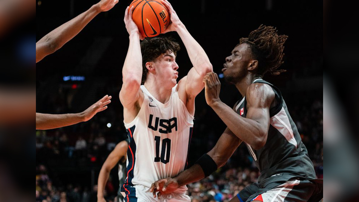 Blake Buchanan #10 of USA Team (center) attempts to get by Michael Nwoko #11 of World Team (R) during the Nike Hoop Summit at the Moda Center on Saturday, April 8, 2023 in Portland, OR. The USA Team went on to win 90-84 over the World Team.