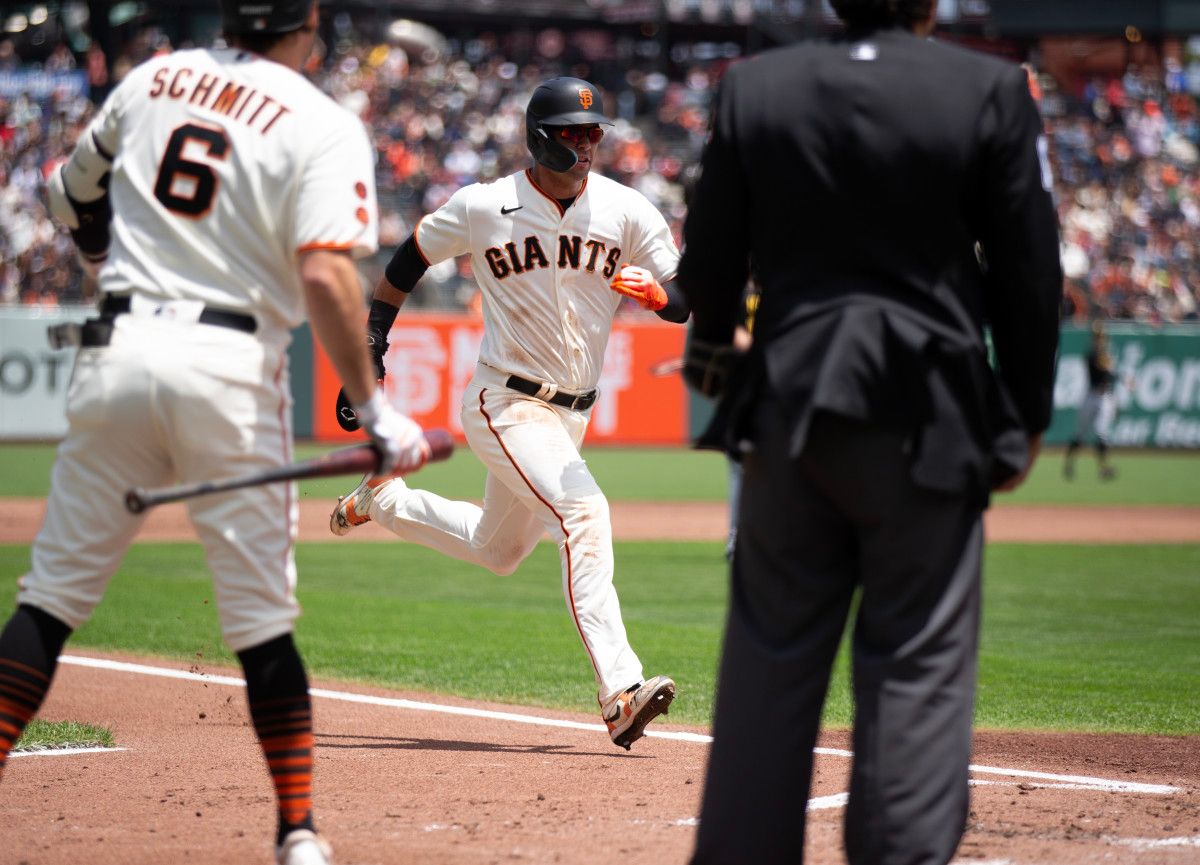SF Giants left fielder Blake Sabol (center) scores on a single by Patrick Bailey against the Pittsburgh Pirates on May 31, 2023.