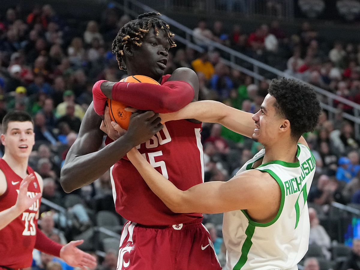 Mar 9, 2023; Las Vegas, NV, USA; Oregon Ducks guard Rivaldo Soares (11) attempts to steal the ball from Washington State Cougars center Adrame Diongue (15) during the first half at T-Mobile Arena. Mandatory Credit: Stephen R. Sylvanie-USA TODAY Sports