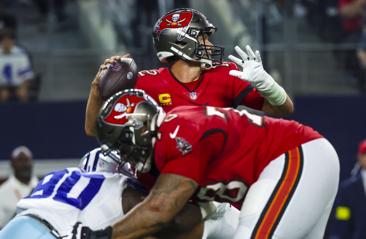 Tom Brady throws as Tampa Bay Buccaneers offensive tackle Tristan Wirfs blocks a Cowboys defensive end
