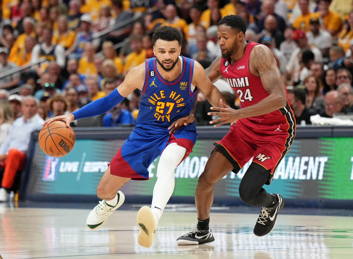 Jamal Murray dribbles the ball past a Heat defender.