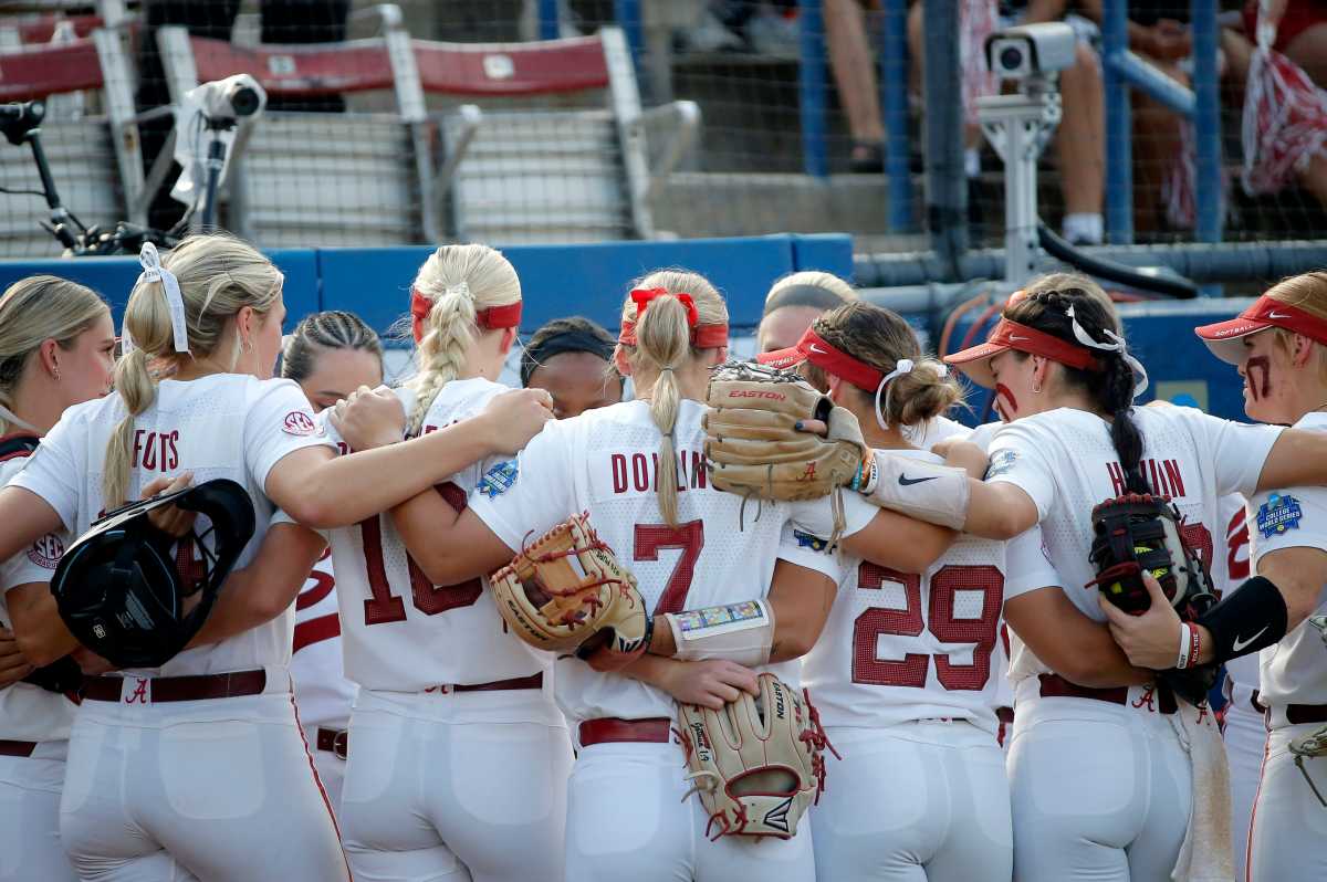 Alabama huddles before a softball game between Alabama and Stanford in the Women's College World Series at USA Softball Hall of Fame Stadium in in Oklahoma City, Friday, June, 2, 2023