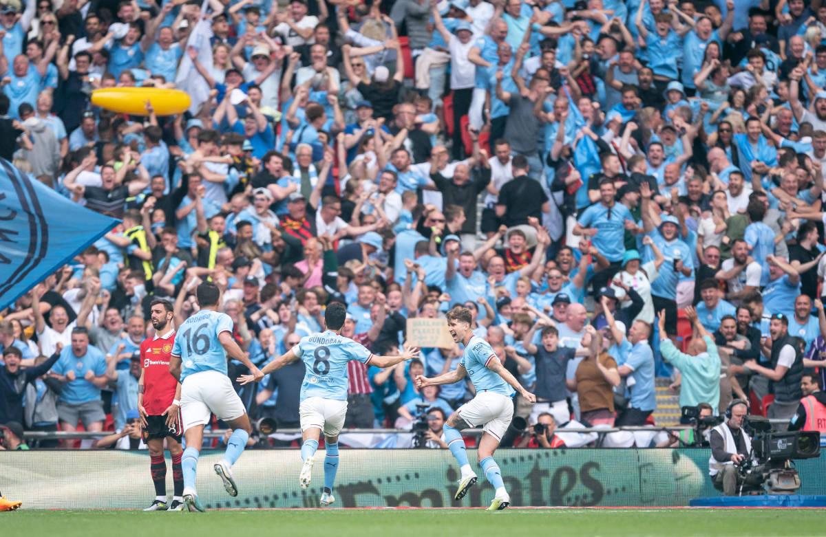 Manchester City players and supporters pictured celebrating a goal during their 2-1 win over Manchester United in the 2023 FA Cup final at Wembley