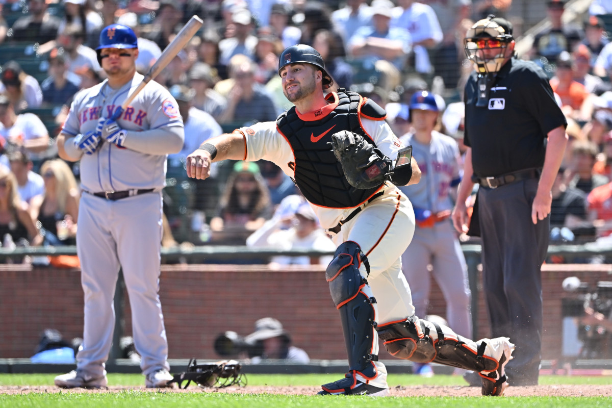 SF Giants catcher Joey Bart throws the ball to third base as New York Mets designated hitter Daniel Vogelbach and home plate umpire Chad Whitson look on during the fourth inning at Oracle Park. (2023)