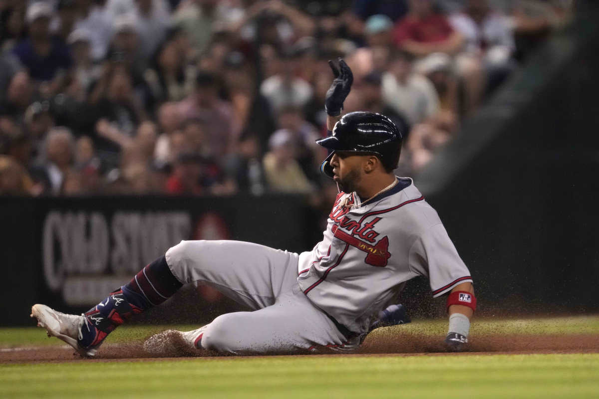 Jun 3, 2023; Phoenix, Arizona, USA; Atlanta Braves left fielder Eddie Rosario (8) slides into third base against the Arizona Diamondbacks during the fourth inning at Chase Field. Mandatory Credit: Joe Camporeale-USA TODAY Sports