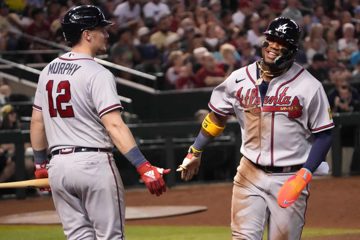 Jun 3, 2023; Phoenix, Arizona, USA; Atlanta Braves right fielder Ronald Acuna Jr. (13) slaps hands with Atlanta Braves catcher Sean Murphy (12) after scoring a run against the Arizona Diamondbacks during the third inning at Chase Field. Mandatory Credit: Joe Camporeale-USA TODAY Sports