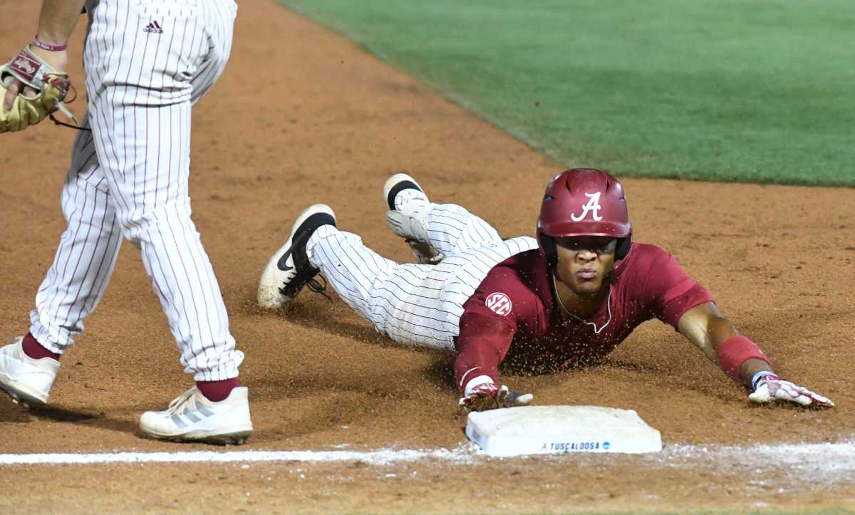 Alabama base runner Andrew Pinckney (21) slides safely into third with a triple in the ninth inning at Sewell-Thomas Stadium in Tuscaloosa, Ala., Saturday June 4, 2023. Alabama defeated Troy 11-8 in the winners bracket game of the NCAA Regional Baseball Tournament.